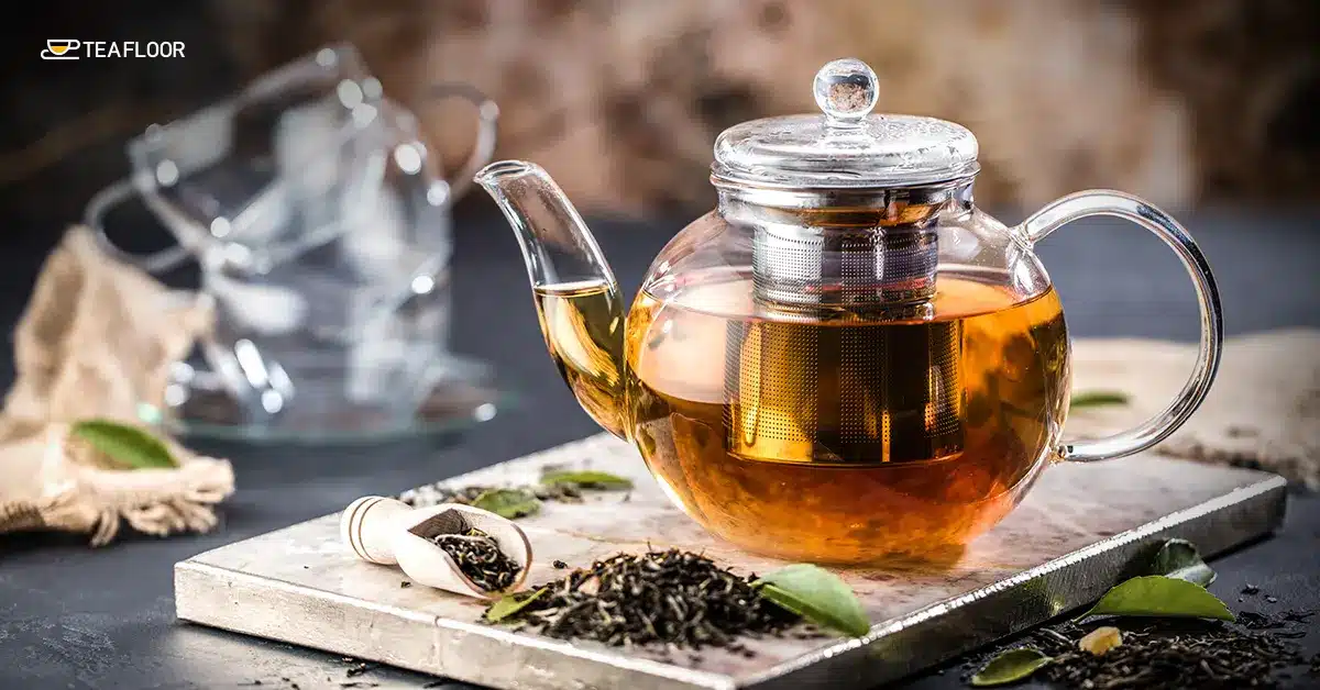 A glass teapot with loose leaves explaining how to brew first flush vs second flush Darjeeling tea perfectly.